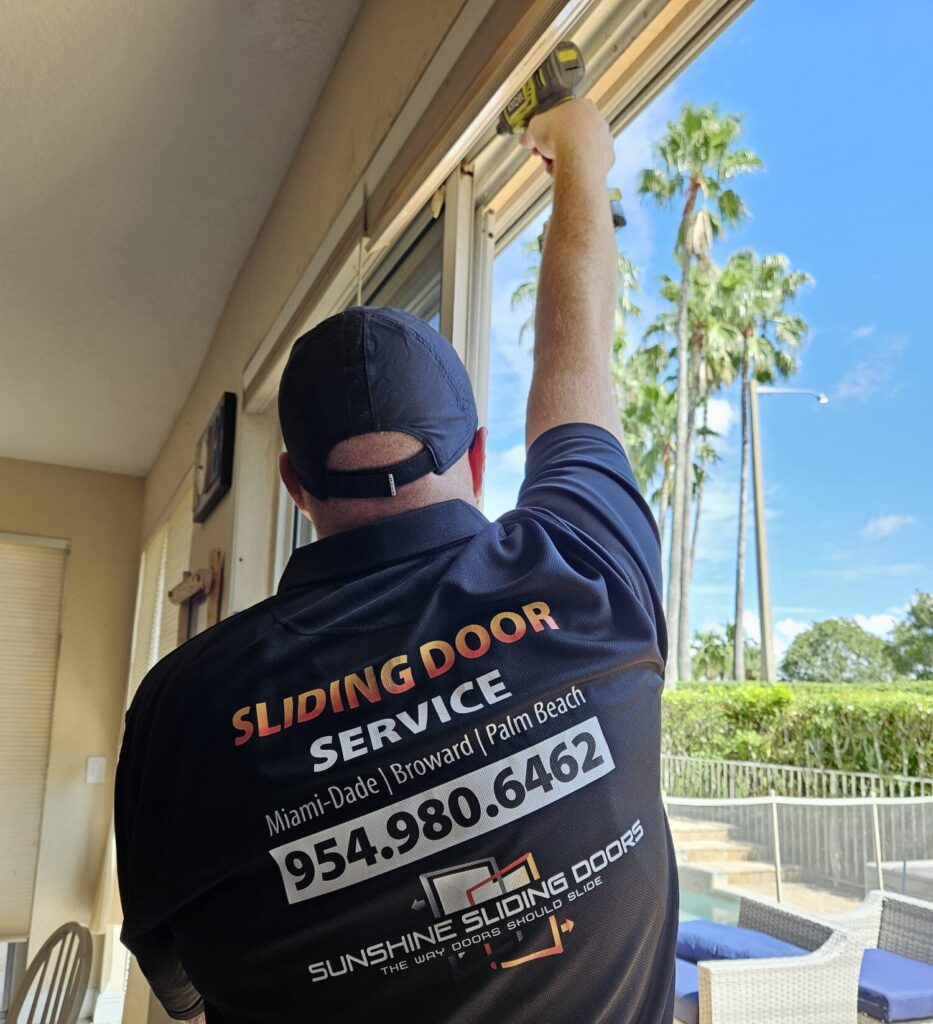 Professional sliding door repair service working on track and rollers in South Florida