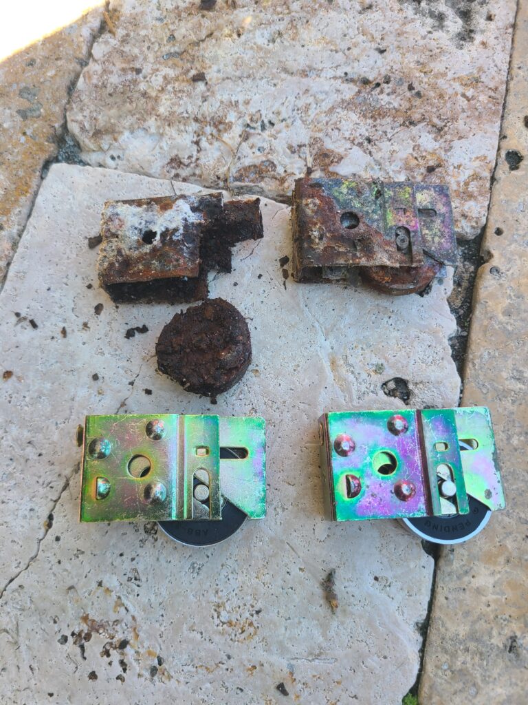 Rusted worn out sliding door rollers causing the door to stick